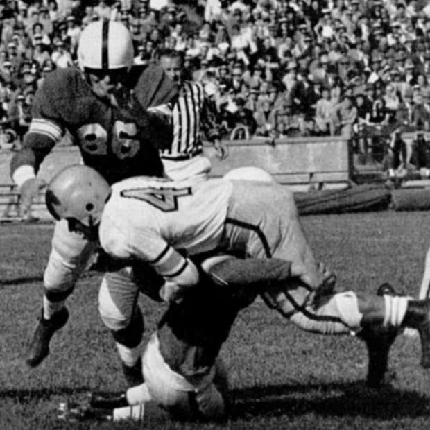 Indiana's Ed Roth stops Iowa's Bob Stearns during a 1952 game at old Memorial Stadium. Leroy Moon (66) is ready to assist on 