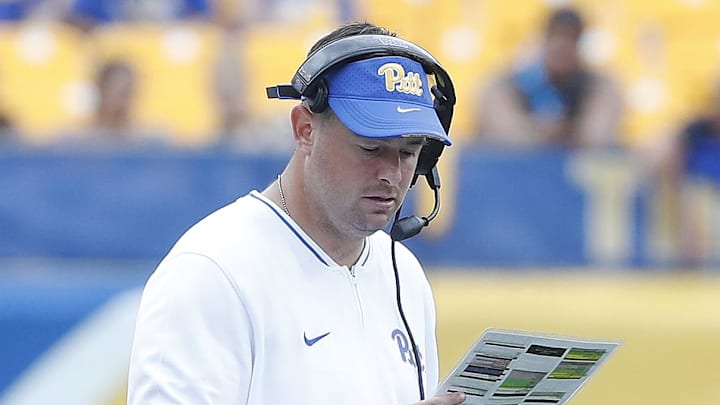Aug 31, 2024; Pittsburgh, Pennsylvania, USA; Pittsburgh Panthers offensive coordinator Kade Bell looks at his play chart against the Kent State Golden Flashes during the fourth quarter at Acrisure Stadium. Mandatory Credit: Charles LeClaire-Imagn Images Aug 31, 2024; Pittsburgh, Pennsylvania, USA; Pittsburgh Panthers offensive coordinator Kade Bell looks at his play chart against the Kent State Golden Flashes during the fourth quarter at Acrisure Stadium. Mandatory Credit: Charles LeClaire-Imagn Images
