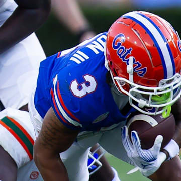 Florida Gators wide receiver Eugene Wilson III (3) is upended during the season opener at Ben Hill Griffin Stadium in Gainesville, FL on Saturday, August 31, 2024 against the University of Miami Hurricanes in the second half. Miami defeated the Gators 41-17. [Doug Engle/Gainesville Sun]