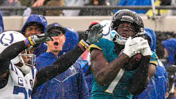 Jacksonville Jaguars wide receiver Brian Thomas Jr. (7) hauls in a pass as Indianapolis Colts cornerback Kenny Moore II (23) pressures him in the third quarter during an NFL football game at EverBank Stadium, Sunday, Dec. 7, 2025, in Jacksonville, Fla. 
