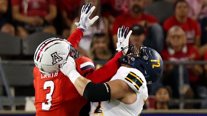 Sep 7, 2024; Tucson, Arizona, USA; Arizona Lumberjacks quarterback Ty Pennington (6) throws the ball against Arizona Wildcats defensive lineman Tre Smith (3) during first quarter at Arizona Stadium