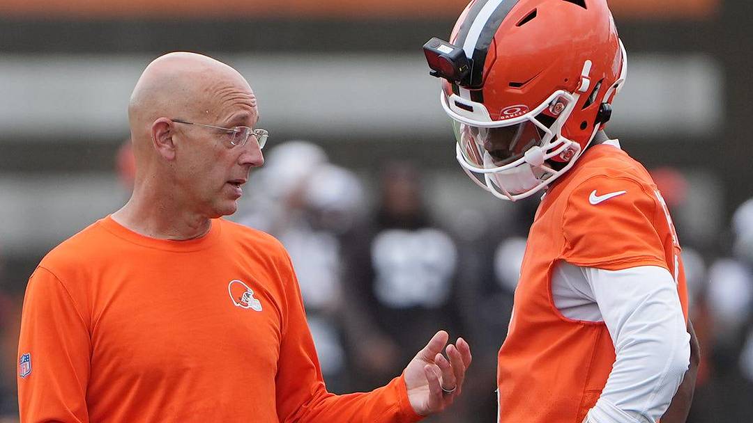 Browns quarterback coach Mike Bajakian talks with Browns quarterback Shedeur Sanders