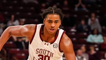 Mar 4, 2025; Columbia, South Carolina, USA; South Carolina Gamecocks forward Collin Murray-Boyles (30) drives around Georgia Bulldogs forward Dylan James (13) in the first half at Colonial Life Arena. Mandatory Credit: Jeff Blake-Imagn Images