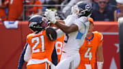 Sep 7, 2025; Denver, Colorado, USA; Denver Broncos cornerback Riley Moss (21) breaks up a catch against Tennessee Titans wide receiver Elic Ayomanor (5) in the second half at Empower Field at Mile High. 