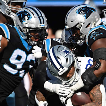 Nov 19, 2023; Charlotte, North Carolina, USA; Dallas Cowboys running back Rico Dowdle (23) is tackled by Carolina Panthers defensive tackles LaBryan Ray (93) and Derrick Brown (95) in the second quarter at Bank of America Stadium. 