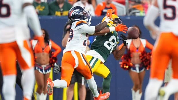 Denver Broncos cornerback Ja'Quan McMillian (29) breaks up a pass to Green Bay Packers wide receiver Bo Melton (80).