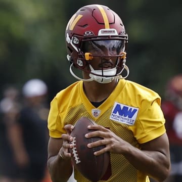 Jul 26, 2024; Ashburn, VA, USA; Washington Commanders quarterback Jayden Daniels (5) and Commanders quarterback Sam Hartman (11) drop back to pass on day three of training camp at Commanders Park. Mandatory Credit: Geoff Burke-USA TODAY Sports