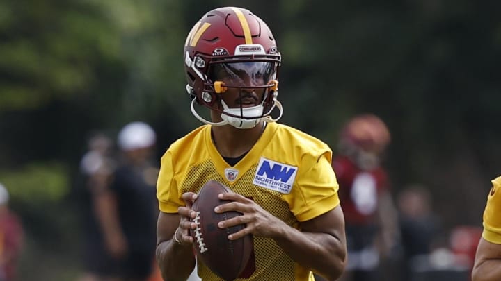 Jul 26, 2024; Ashburn, VA, USA; Washington Commanders quarterback Jayden Daniels (5) and Commanders quarterback Sam Hartman (11) drop back to pass on day three of training camp at Commanders Park. Mandatory Credit: Geoff Burke-USA TODAY Sports