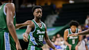 Tulane guard Asher Woods, center, is congratulated after making a foul shot against UNO on Nov. 22. Tulane coach Ron Hunter said is pleased by Woods' perimeter defense this season.