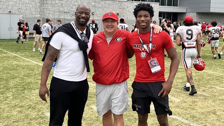 Chauncey Davis Jr. (right) poses with his father, seven-year NFL defensive lineman Chauncey Daivs Sr. (left) and Georgia Bulldogs head football coach Kirby Smart during a visit to Georgia's campus April 2, 2024.