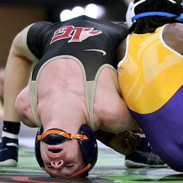 Ariah Mills (right) of Athens Christian remains the top-ranked wrestler in the nation, in the 106-pound division on Saturday.