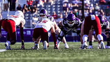 Cooper Lovelace and Northwestern's offensive line at the line of scrimmage.