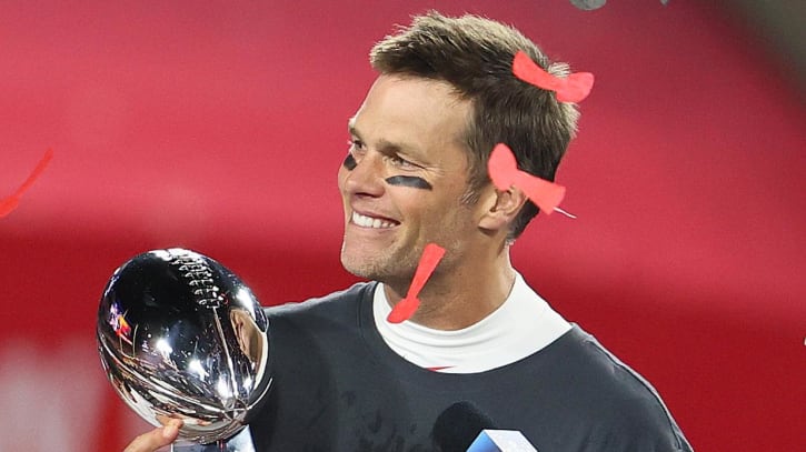 Feb 7, 2021; Tampa, FL, USA; Tampa Bay Buccaneers quarterback Tom Brady (12) hoists the Vince