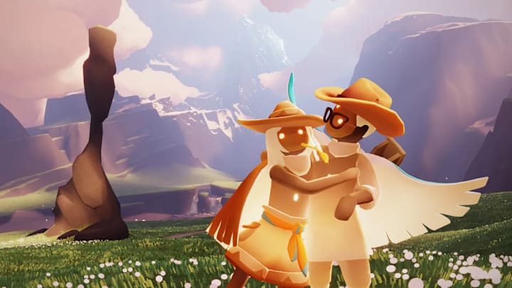 Two characters with hats embrace each other in a mountain range in Sky: Children of the Light.
