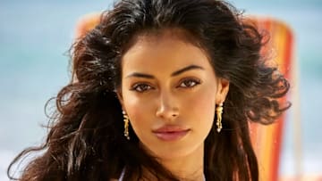 Cindy Kimberly was photographed by Ben Watts in Barbados. Swimsuit by Andi Bagus. Earrings by En Route Jewelry.
