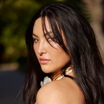 Yumi Nu was photographed by Derek Kettela in Belize. Swimsuit by MESHKI. Necklace by Alexis Bittar.