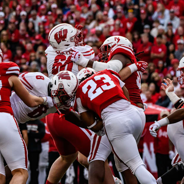 Dante Dowdell (23) pushes through a slew of Wisconsin tacklers. 