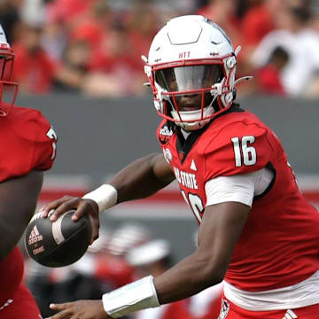 Nov 2, 2024; Raleigh, North Carolina, USA;  North Carolina State Wolfpack quarter back CJ Bailey (16) drops the ball back for a pass during the second quarter against Stanford Cardinals at Carter-Finley Stadium. Mandatory Credit: Zachary Taft-Imagn Images