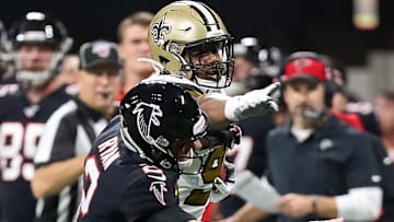 New Orleans Saints DT Shy Tuttle (90) stiff-arms Atlanta Falcons QB Matt Ryan after intercepting him on Nov. 28, 2019.
