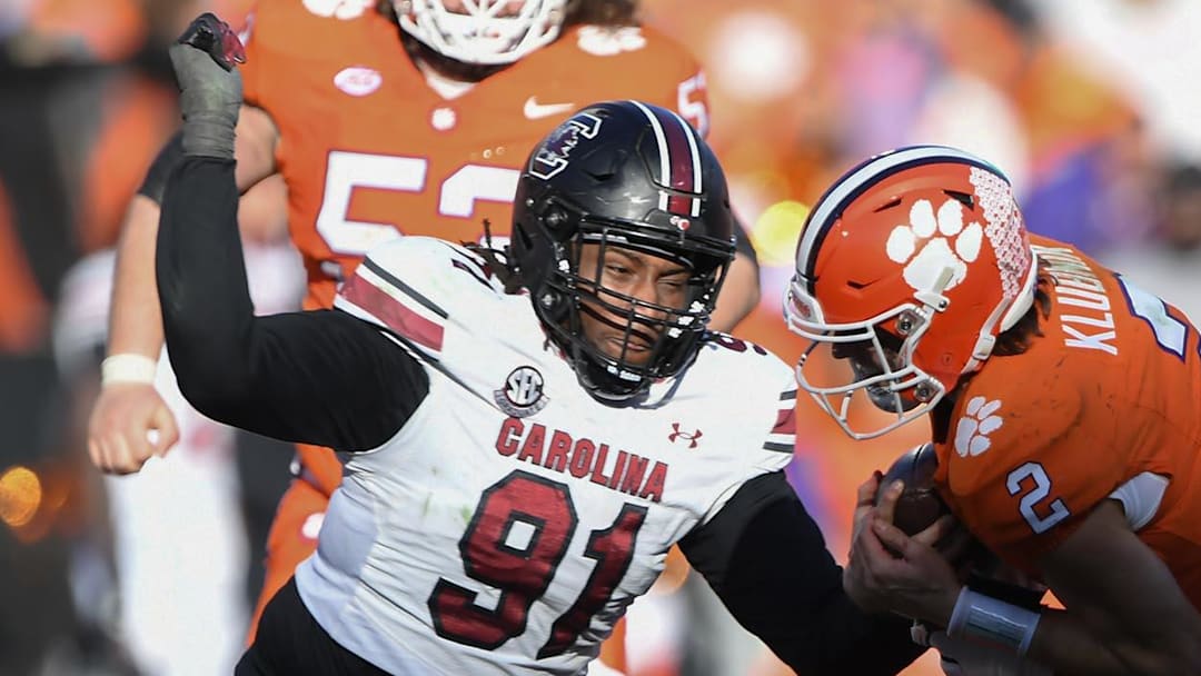 Nov 30, 2024; Clemson, South Carolina, USA; Clemson quarterback Cade Klubnik (2) is tackled by South Carolina defensive tackle Tonka Hemingway (91) and South Carolina linebacker Demetrius Knight Jr (17) during the fourth quarter at Memorial Stadium. Mandatory Credit: Ken Ruinard-Imagn Images