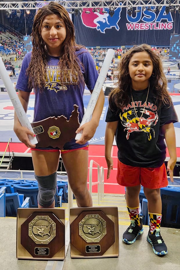 Taina Fernandez shows off her Fargo hardware, while posing for a photo with her little brother.