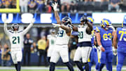 Jan 5, 2025; Inglewood, California, USA; Seattle Seahawks Defensive End Leonard Williams (99), Free Safety Devon Witherspoon (21) and Nose Tackle Jarred Reed (90) celebrate a 4th down stop at SoFi Stadium, as the Seattle Seahawks face off versus the Los Angeles Rams Week 18 matchup. 