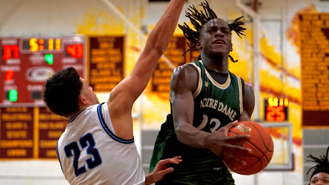 Abou Toure attempts a contested layup as he is guarded by East Catholic's Juan Padilla during Notre Dame-West Haven's 60-47 win against East Catholic in the CIAC Division I quarterfinals. 
