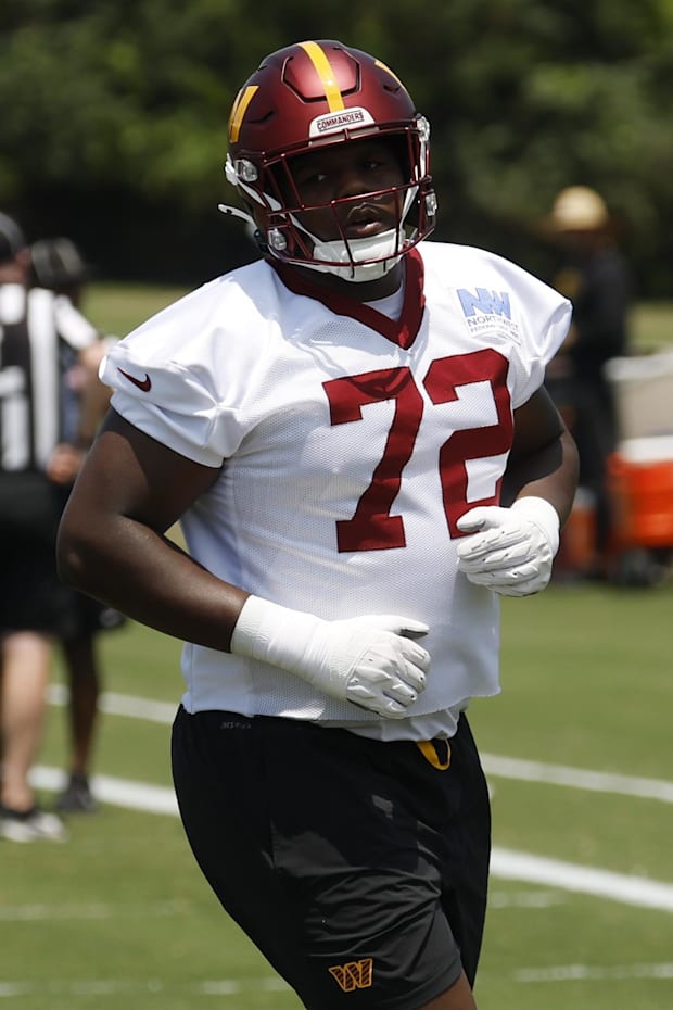 Washington Commanders offensive tackle Josh Conerly Jr. jogs on the field during drills