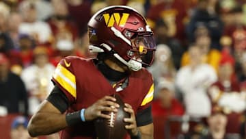 Dec 29, 2024; Landover, Maryland, USA; Washington Commanders quarterback Jayden Daniels (5) prepares to pass the ball against the Atlanta Falcons during the fourth quarter at Northwest Stadium. Mandatory Credit: Geoff Burke-Imagn Images