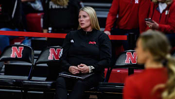 In her first game, coach Dani Busboom Kelly watches pre-game warmups. 