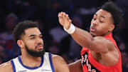 New York Knicks center Karl-Anthony Towns is guarded by Toronto Raptors forward Scottie Barnes