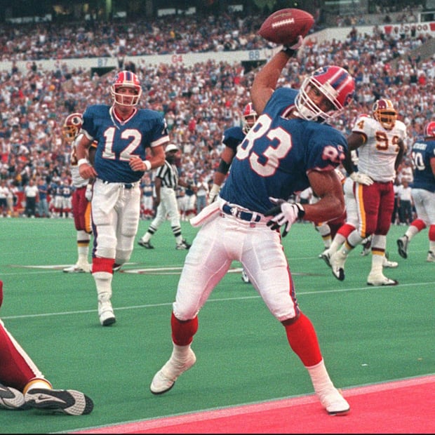 Buffalo Bills WR Andre Reed spikes the ball after a TD catch.
