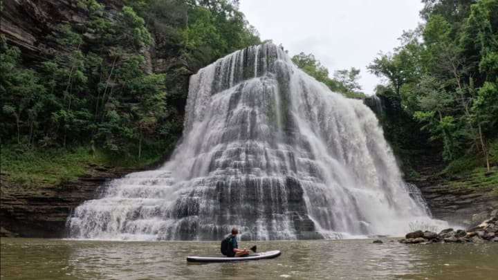 Person in a paddleboat going past Burgess Falls in Tennessee.