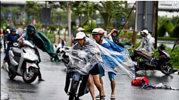 Motorcyclists struggle from the strong wind of Typhoon Yagi in Haiphong, Vietnam, on Saturday.