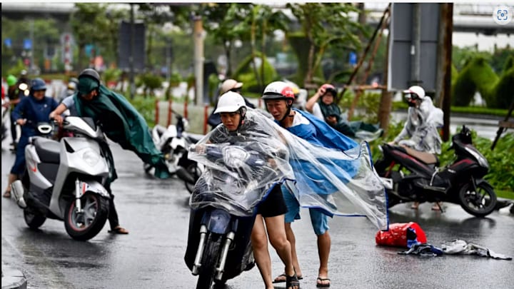 Motorcyclists struggle from the strong wind of Typhoon Yagi in Haiphong, Vietnam, on Saturday.