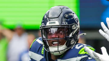 San Francisco 49ers wide receiver Ricky Pearsall catches a pass against Seattle Seahawks cornerback Riq Woolen.