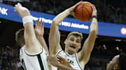 Michigan State Spartans center Carson Cooper leaps and grabs a rebound against the Iowa Hawkeyes on Tuesday, Dec. 2, 2025, at the Breslin Center.