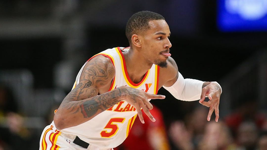 Jan 10, 2024; Atlanta, Georgia, USA; Atlanta Hawks guard Dejounte Murray (5) reacts after a three-pointer against the Philadelphia 76ers in the second quarter at State Farm Arena. Mandatory Credit: Brett Davis-Imagn Images

