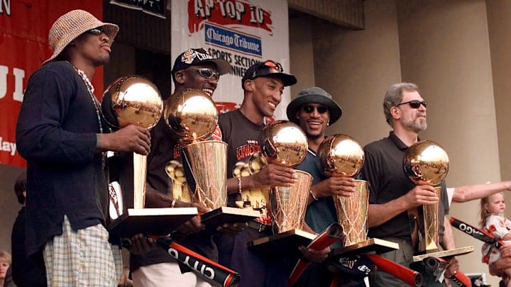 Jun 16, 1997; Chicago, IL, USA; Chicago Bulls players, left to right, Ron Harper, Dennis Rodman, Scottie Pippen, Michael Jordan & coach Phil Jackson hold up the Bulls' five championship trophies at a rally in Grant Park. Mandatory Credit: Anne Ryan-USA TODAY Jun 16, 1997; Chicago, IL, USA; Chicago Bulls players, left to right, Ron Harper, Dennis Rodman, Scottie Pippen, Michael Jordan & coach Phil Jackson hold up the Bulls' five championship trophies at a rally in Grant Park. Mandatory Credit: Anne Ryan-USA TODAY