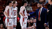 Utah women's basketball coach Gavin Petersen gives instructions to his team during a 2024-25 game.