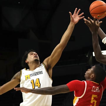 Nov 9, 2025; Columbia, Missouri, USA; Missouri Tigers senior forwards Mark Mitchell (25) and Jevon Porter (14) go up for the ball against VMI junior guard AJ Clark (5) during a matchup against the Keydets at Mizzou Arena. 