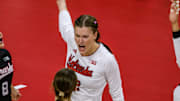 The Huskers celebrate Lindsay Krause's kill.  