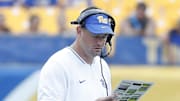 Aug 31, 2024; Pittsburgh, Pennsylvania, USA;  Pittsburgh Panthers offensive coordinator Kade Bell looks at his play chart against the Kent State Golden Flashes during the fourth quarter at Acrisure Stadium. Mandatory Credit: Charles LeClaire-Imagn Images