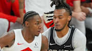 Toronto Raptors forward/guard RJ Barrett dribbles against San Antonio Spurs guard Stephon Castle.