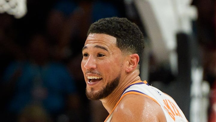 Nov 16, 2025; Phoenix, Arizona, USA; Phoenix Suns guard Devin Booker (1) reacts and smiles during the second half of play against the Atlanta Hawks at Mortgage Matchup Center. Mandatory Credit: Allan Henry-Imagn Images