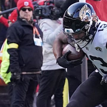 Nov 13, 2022; Kansas City, Missouri, USA; Jacksonville Jaguars wide receiver Christian Kirk (13) runs the ball as Kansas City Chiefs safety Justin Reid (20) makes the tackle during the second half of the game at GEHA Field at Arrowhead Stadium. Mandatory Credit: Denny Medley-Imagn Images