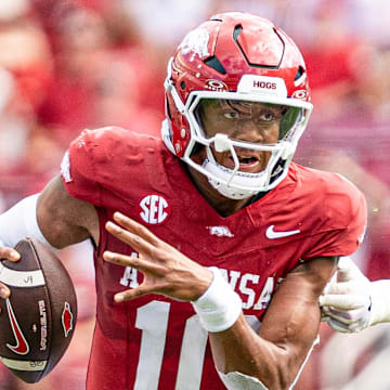 Arkansas Razorbacks quarterback Taylen Green runs through an opening in the UAB Blazers' defense Saturday afternoon at Razorback Stadium in Fayetteville, Ark.