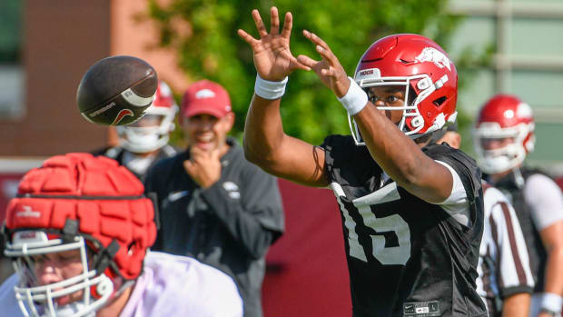 Razorbacks quarterback KJ Jackson taking a snap in practice.