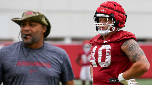 Razorbacks lineman Landon Jackson with coach Deke Adams at summer practice