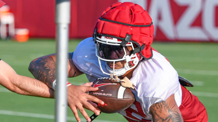 Arkansas Razorbacks running back Ja'Quinden Jackson takes a handoff during drills in fall camp Aug. 5, 2024, in Fayetteville, Ark.